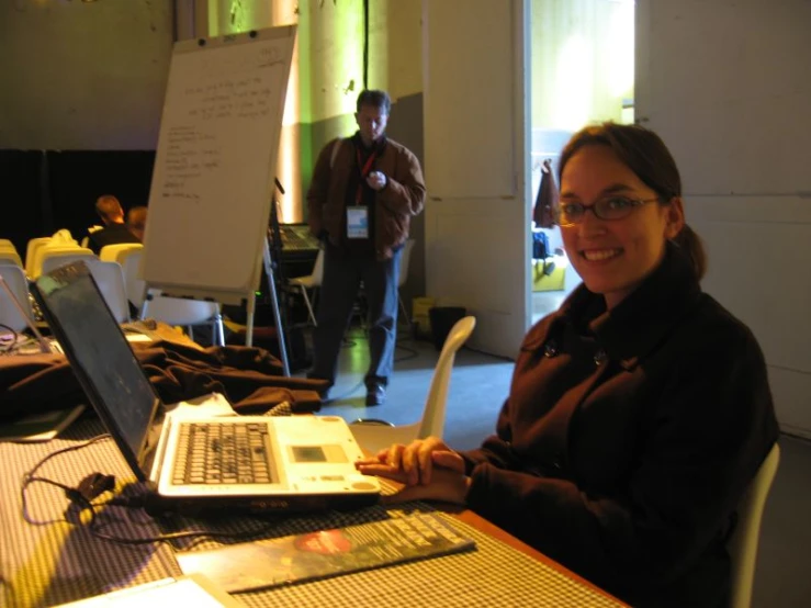 a woman smiling while working on her laptop