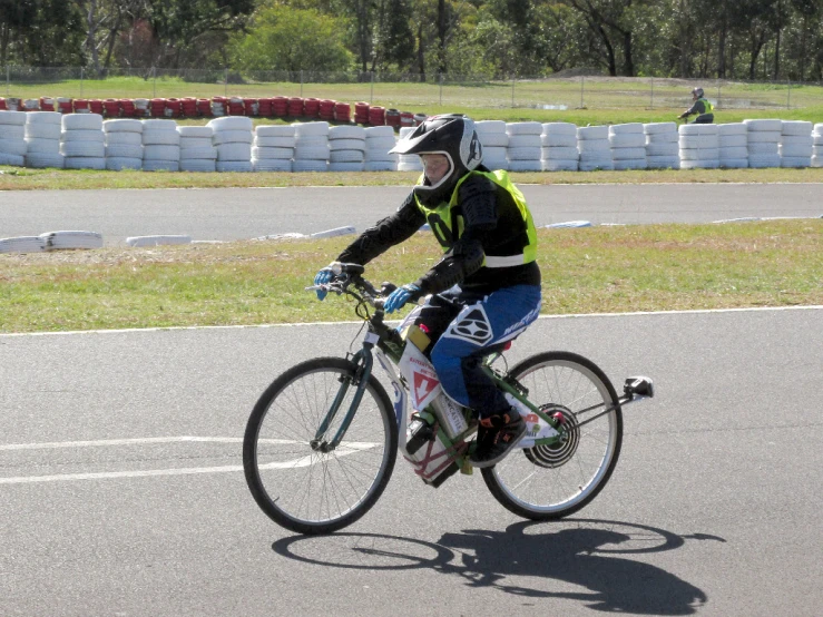 a young man is riding his bike around the track