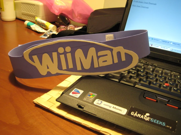 a headband that says wilman on it next to a laptop