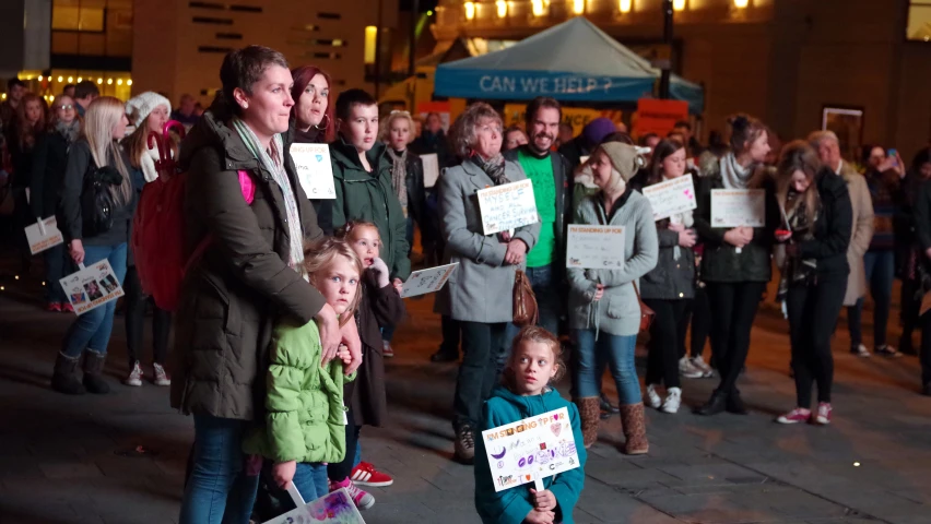 people holding signs protesting and posing for the camera