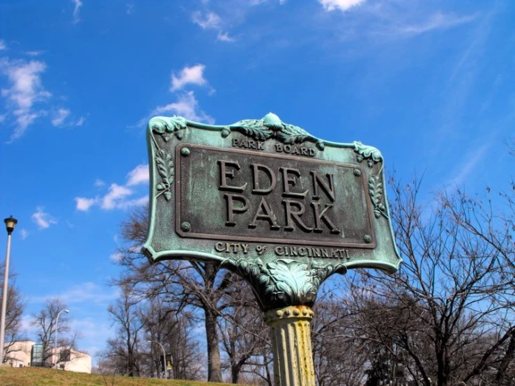 a public park with an interesting sign in the background