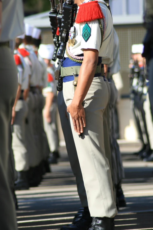 an uniformed man in uniform holds a rifle