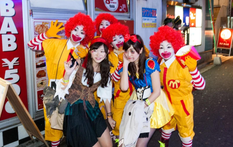 a group of young people are dressed up as clowns