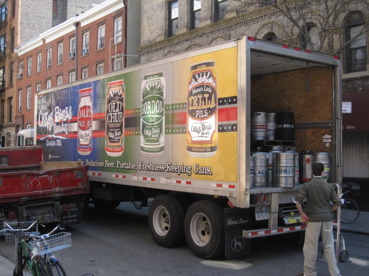 a truck with various beer advertit on it's trailer