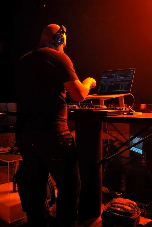 a dj mixes a set up in the dark