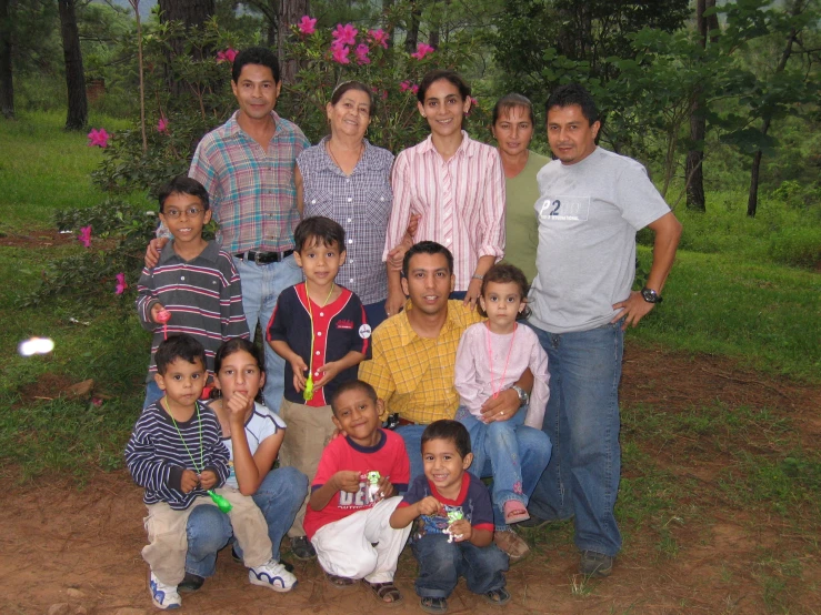 a family posing in the grass together