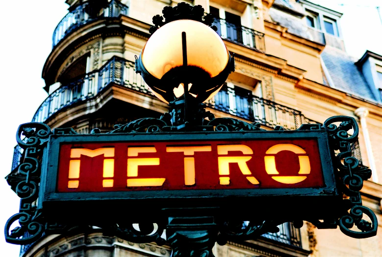 the old streetlight stands by the metro sign