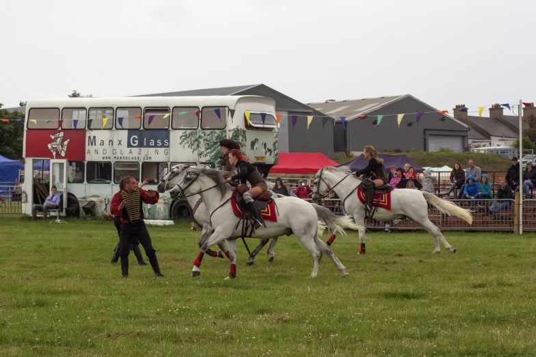 a group of people on horseback in a field