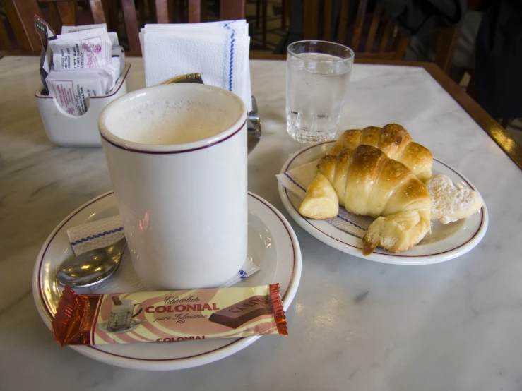 two plates and cups sitting on a table