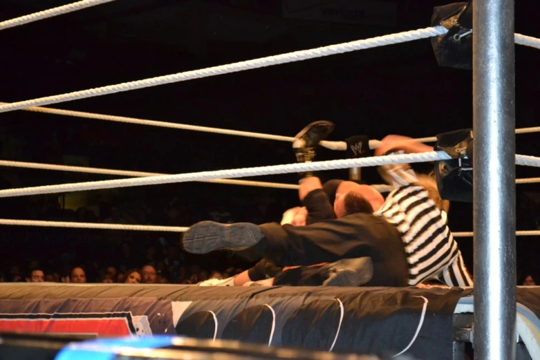 two men standing on top of a metal ring