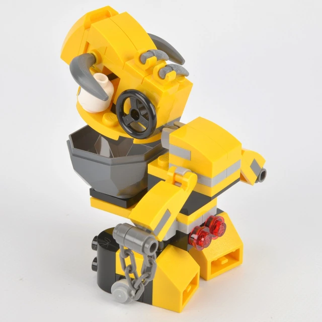 a lego building toy with no wheels and a bee holding an object
