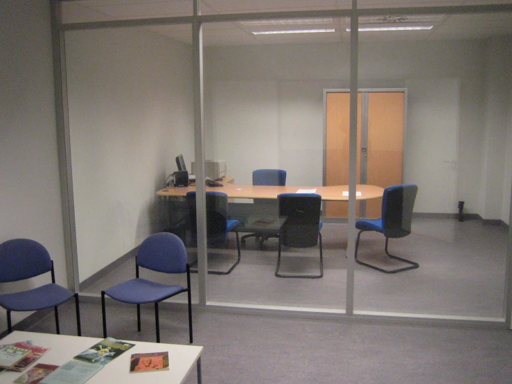 a conference room has chairs in it and a small white table
