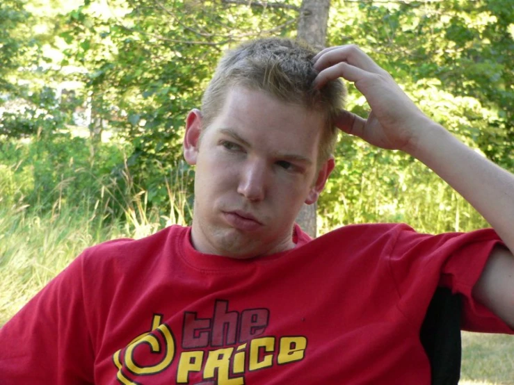 a man is sitting in a chair and posing for the camera