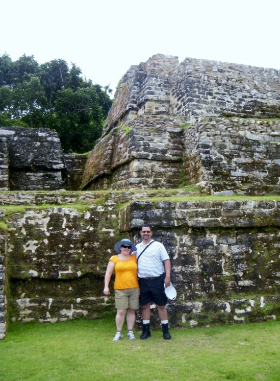 two people standing near a large building made of bricks