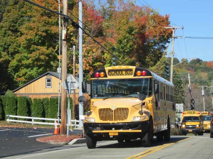 school buses are traveling on the street