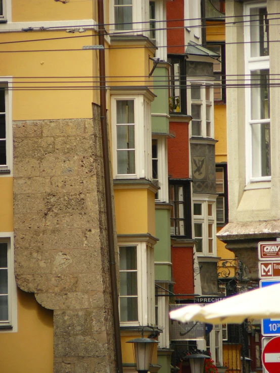 colorful buildings with white windows and a large umbrella