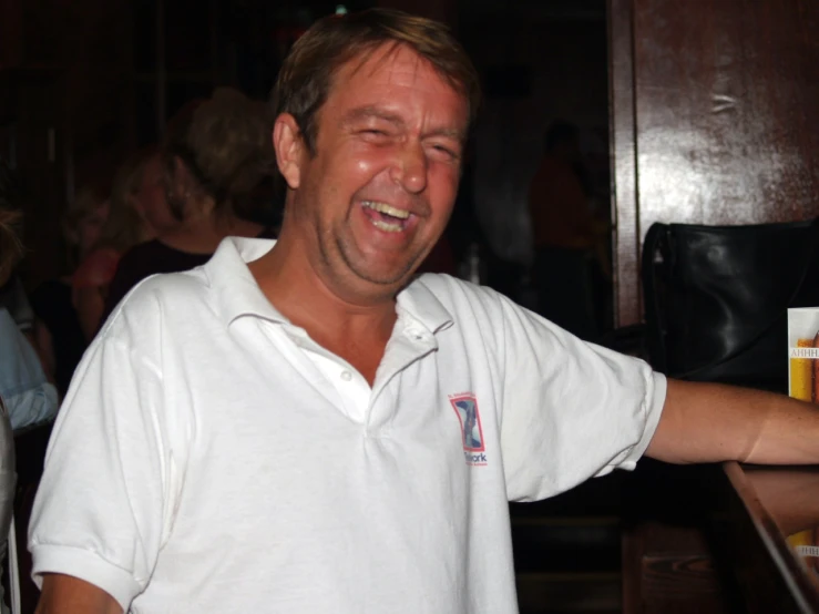 a man in a white shirt has his eyes closed