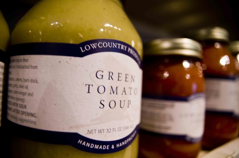 jars of green tomatoes in rows on shelf