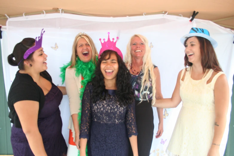 there are six women in party hats one has a purple hat