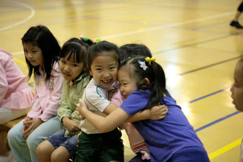 a group of little girls sitting around each other