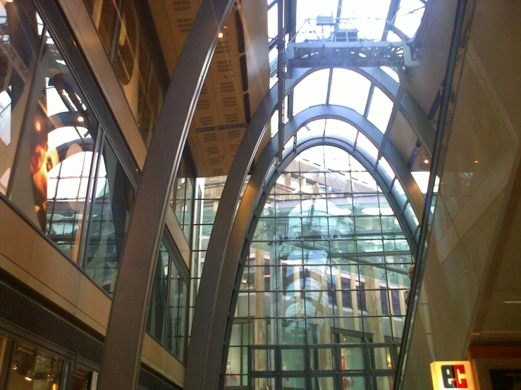 the inside of an indoor building with various glass and steel architecture