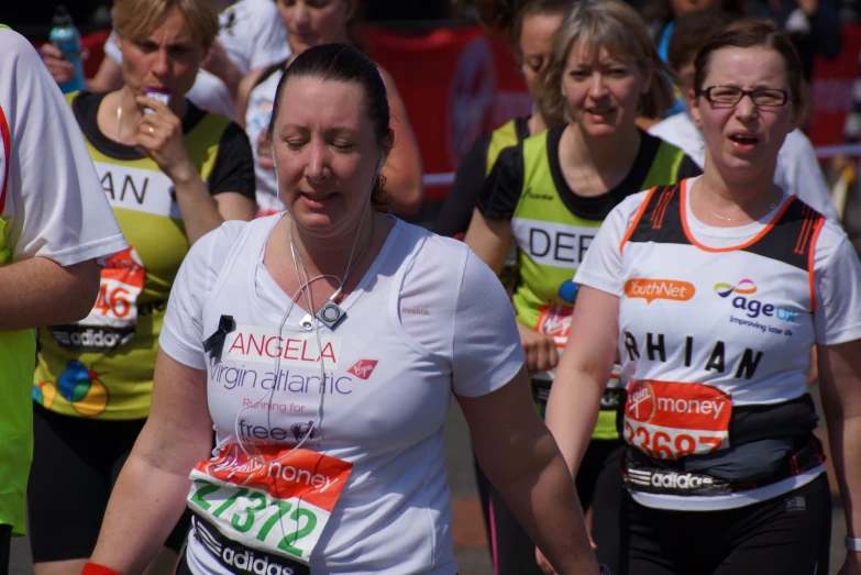 the women are running a marathon in colorful shirts