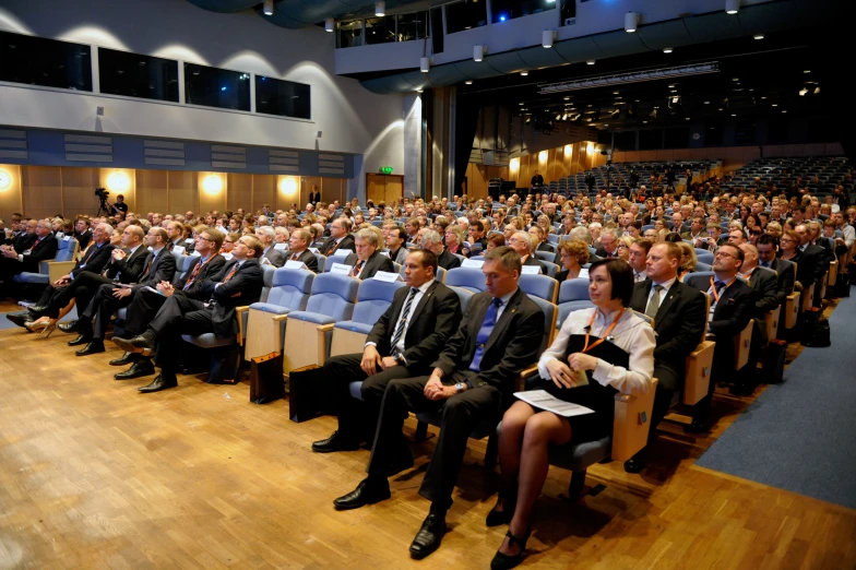 an audience looks at a lecture as it begins