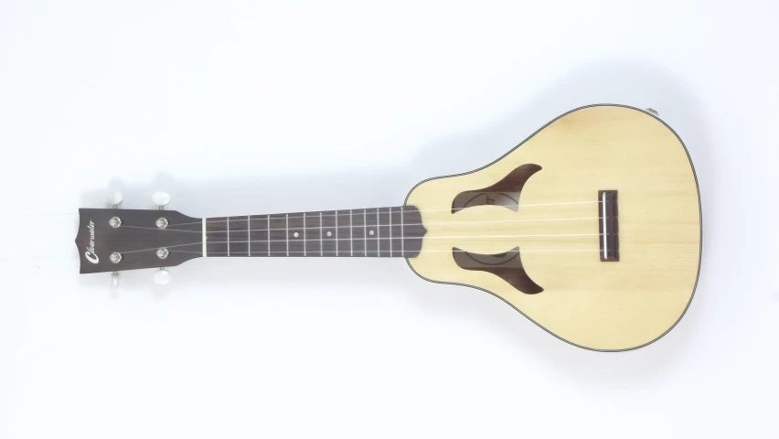 an ukulele is sitting up against a white wall