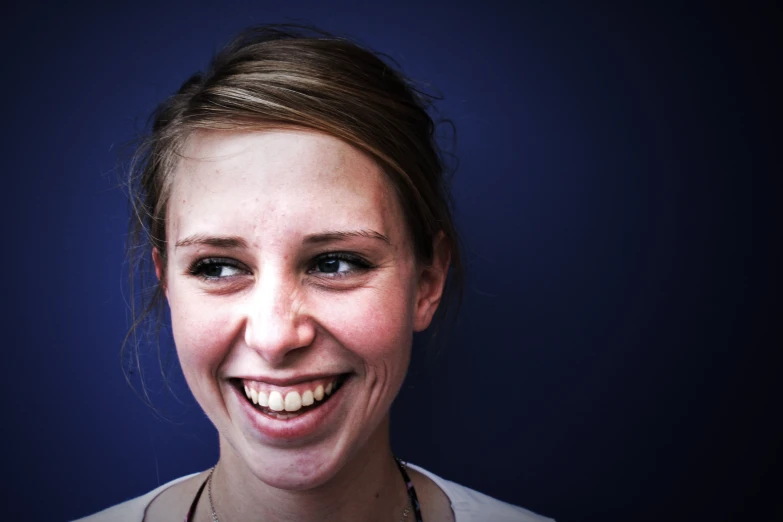 a close up of a woman wearing a necklace with an open mouth