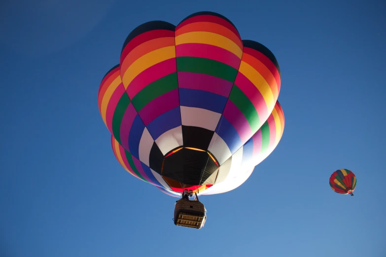 a multicolored  air balloon flying in the sky