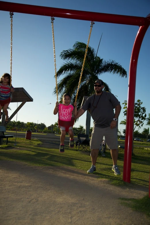 there are people in the swings near one another