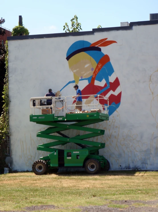 a mural is being painted on the wall of a building