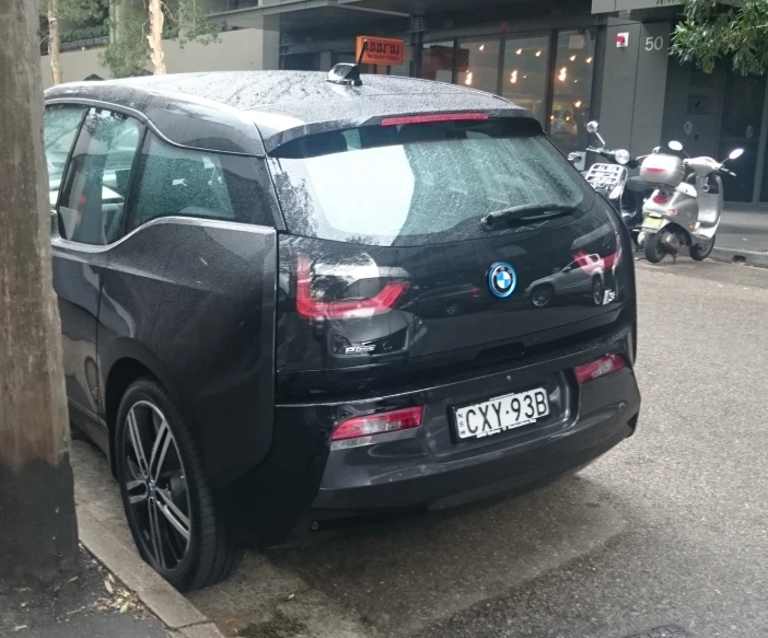 a bmw suv that is parked on the street