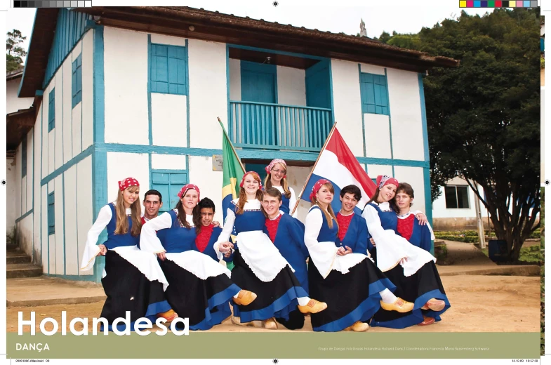 a group of girls standing next to each other in front of a house