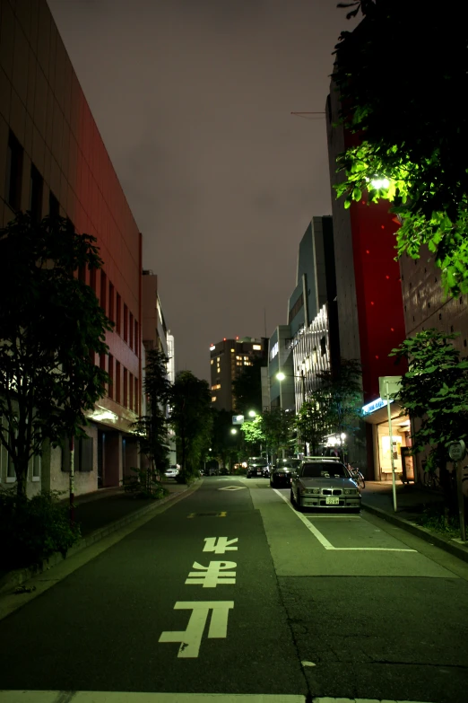 an empty street is lit up at night