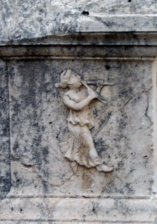 the carvings on this stone are depicting a person with a gun