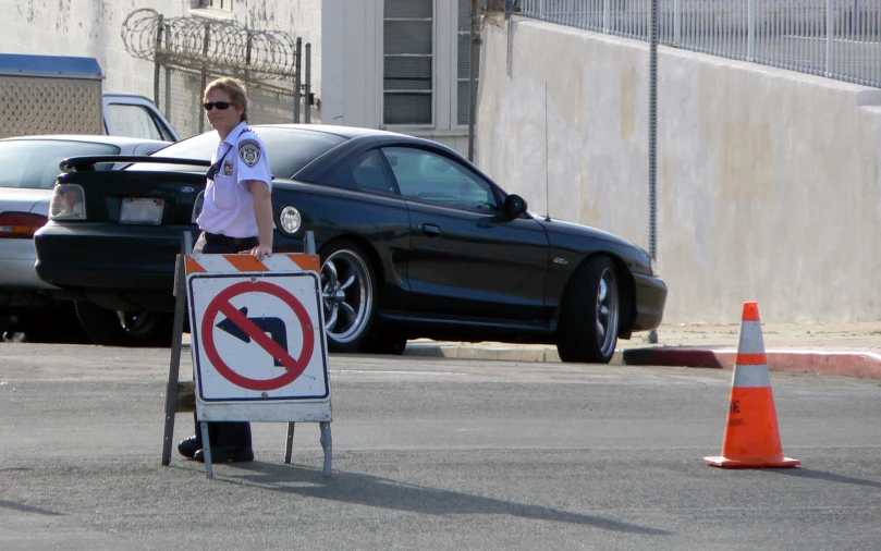 the officer is crossing the street behind a no right turn sign