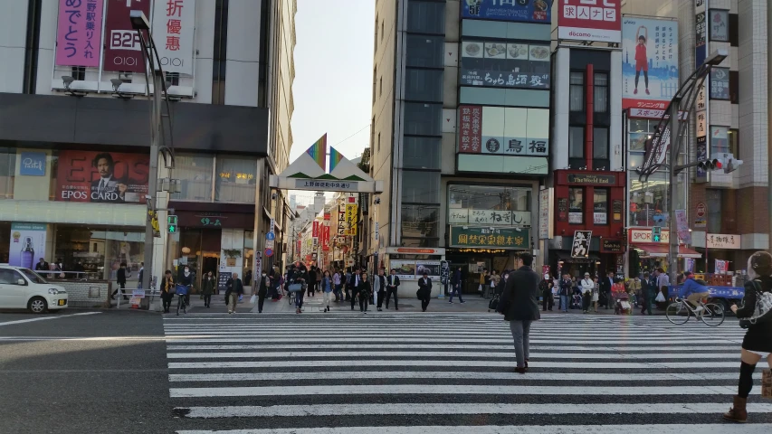 people crossing at the crosswalk in a large city