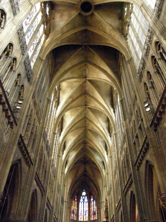 the interior of a building with people walking through it