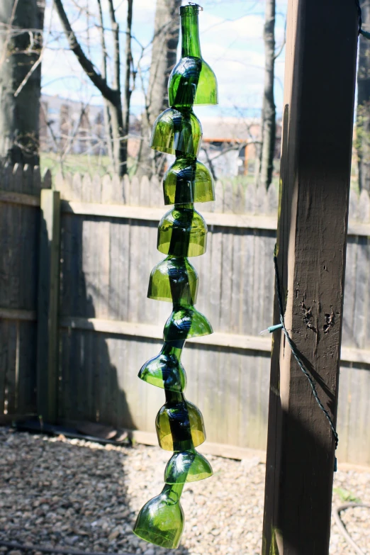 a glass bottle art sculpture in a backyard