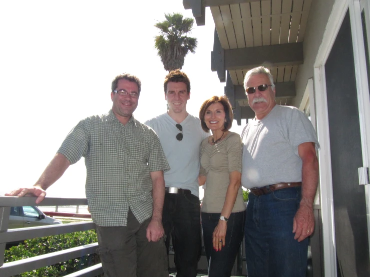 a group of people posing for the camera outside