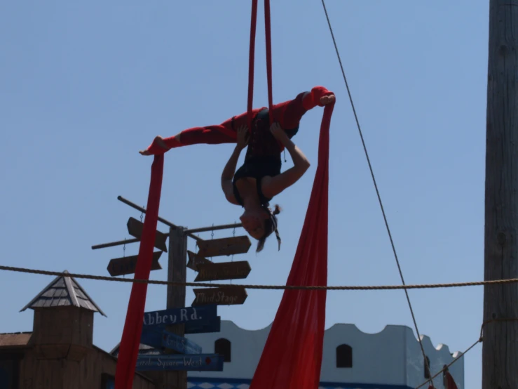 the man is performing a trick on a rope course