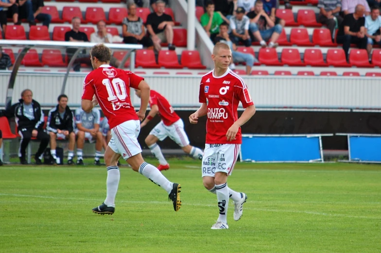 three men are playing soccer on a field