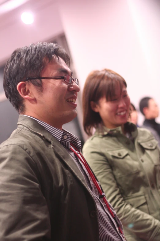 two smiling people sit together at an event