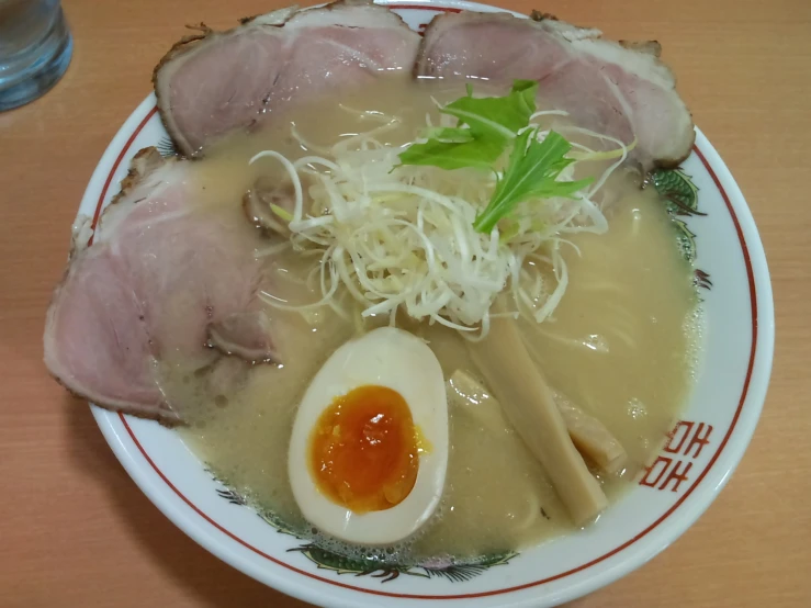 a plate that has soup in it and some vegetables