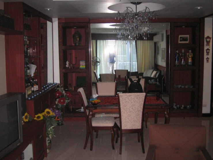 a formal living room with chairs, and wooden cabinets