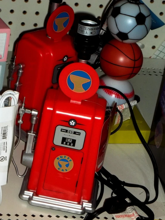 a red gas pump next to some items on the floor