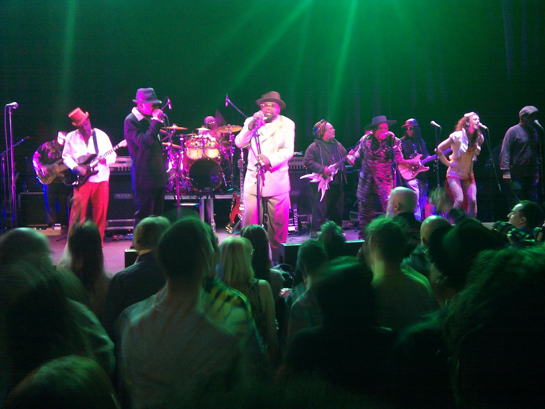 a group of people that are on stage with musical instruments