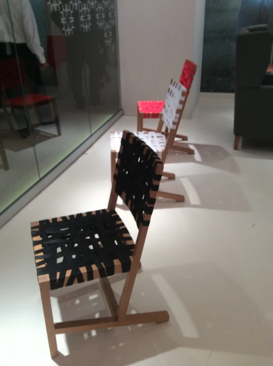 two chairs sitting next to each other in front of a glass wall