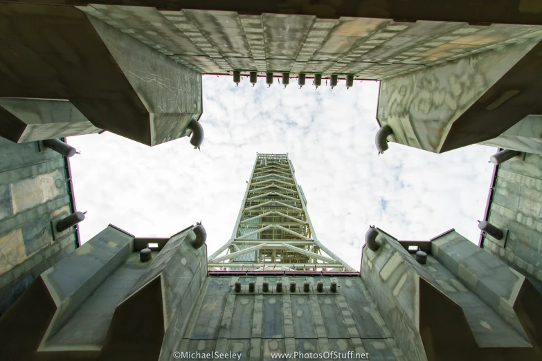 looking up at the bottom of a building through perspective